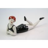 A ceramic figure of a flapper girl