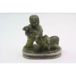 A vintage carved green agate figure in the form of a boy with sheep.