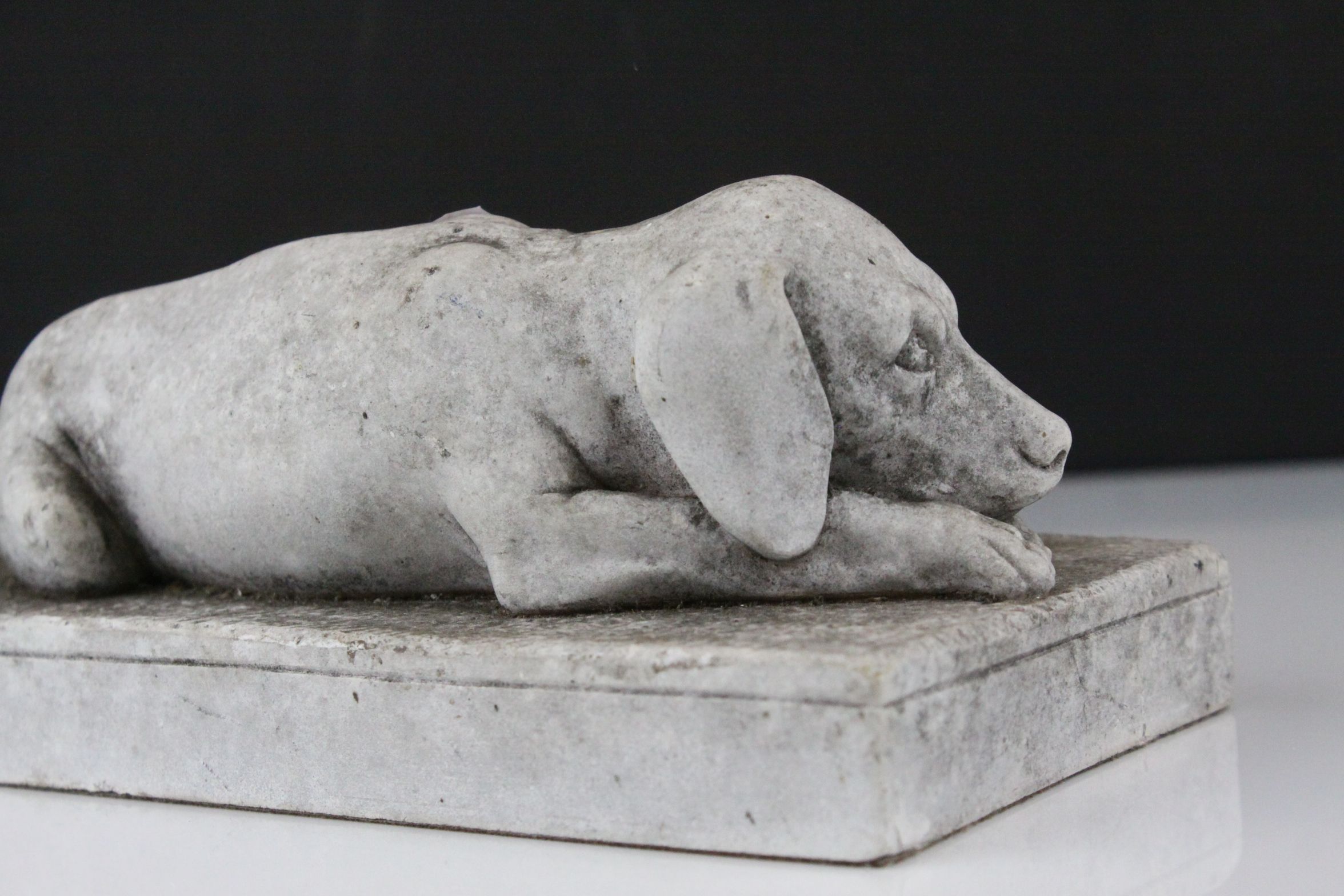 A stone effect scuplture of a recumbent dog. - Image 3 of 4