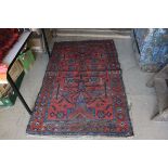 Eastern Red and Blue Ground Wool Rug with Stylised Pattern within a Border, approx.. 188cms x