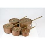 Set of Five Copper Graduating Saucepans with Brass Handles and Lids, largest pan 24cms diameter