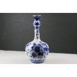 A 20th century blue and white onion shaped vase with floral decoration.
