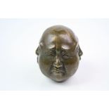 A bronze four faced buddha head paperweight.