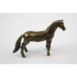 A bronze/brass figure of a horse.