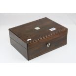 An antique rosewood box with mother of pearl inlay.