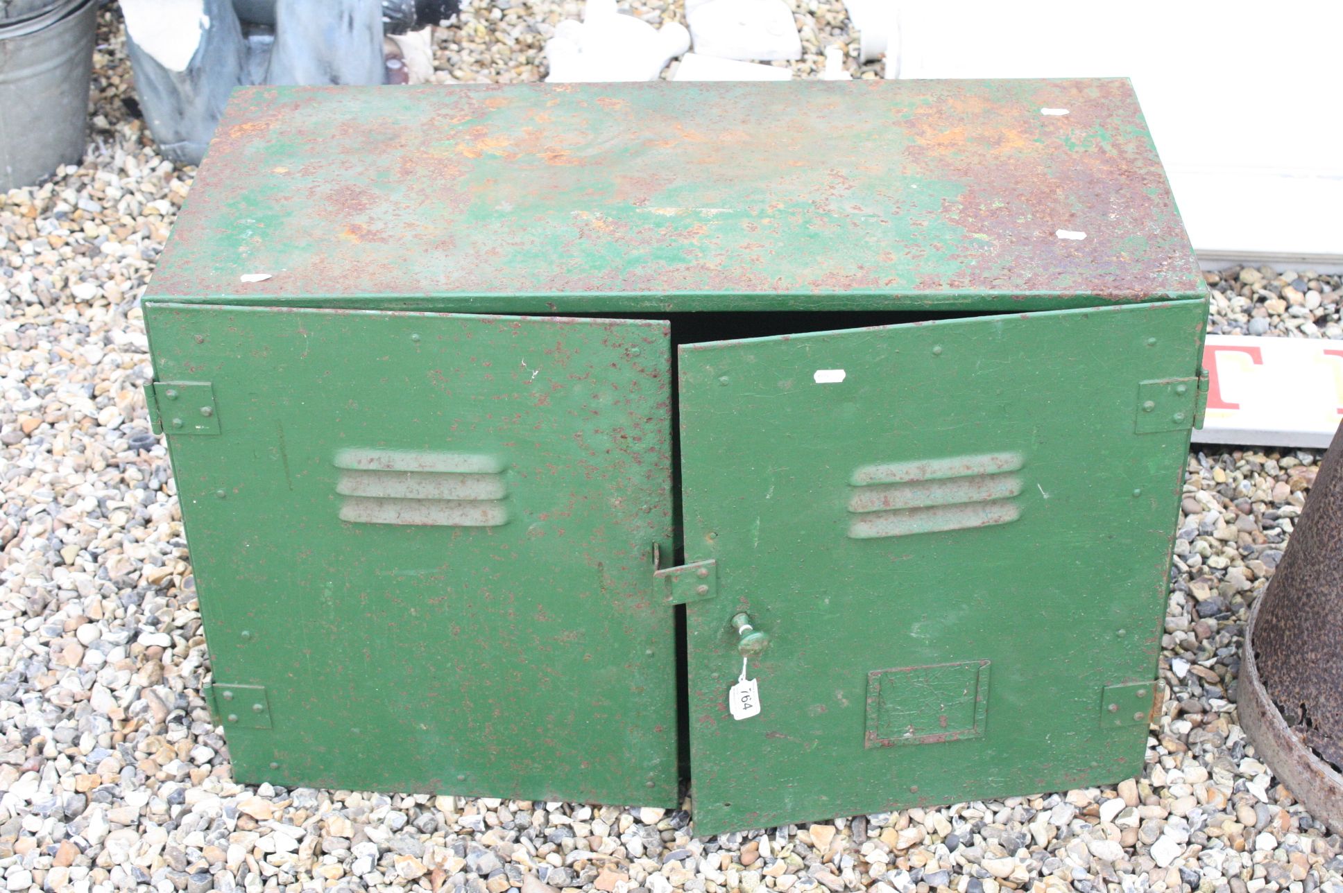 A green painted two door industrial cabinet.