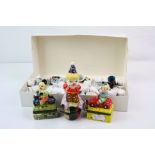 A collection of ceramic thimbles together with three ceramic clown trinket boxes