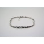 A silver CZ and tourmaline paneled bracelet