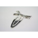 A silver bookmark with dog finial