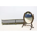 19th century Oval Framed Swing Mirror together with a Brass and Iron Pierced Fire Fender raised on