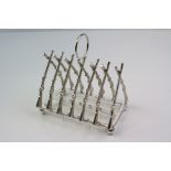 A silver plated Toast rack of rifle form