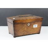 A 19th century rosewood sarcophagus tea caddy with fitted interior.