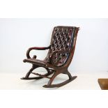 Victorian Style Rocking Chair with open scroll arms and upholstered in red leather button