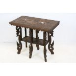 South East Asian Hardwood Table, the top carved with a scene of an Elephant and a Tiger, raised on