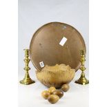 A large copper salver, a pair of brass candlesticks and a treen bowl with wooden eggs.