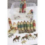 A group of wooden early 20th century skittles in the form of men together with carved naive