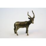 A bronze/brass figure of an antelope.