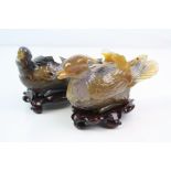 A pair of oriental carved stone trinket box ornaments in the form of ducks.