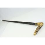 An antler handled walking stick with brass mount.