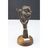 Bronze Sculpture of a Theatrical Mask being held high by a Hand, on wooden circular plinth,