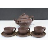 Chinese Yixing bisque teapot together with three cups and saucers.