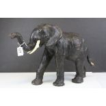 Leather Covered Elephant with faux ivory tusks, 31cms high