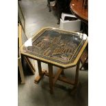 Mid 20th century South East Asian Folding Coffee Table, the glass covered top with relief carved