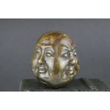 A four faced bronze buddha head signed to underside.