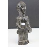 Hardwood Carved Tribal Figure of a Man holding a Club, 28cms high