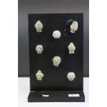 Eight Burmese Ceramic Fertility Heads mounted on a Display Board, each head approximately 4cms high