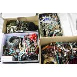 Four shoe boxes of assorted costume jewellery to include necklaces, bangles etc