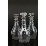 Set of Three George III Glass Decanters with faceted panels and a wheel cut horizontal panel, triple