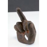 Cast Iron Door Stop in the form of a hand giving gesture.