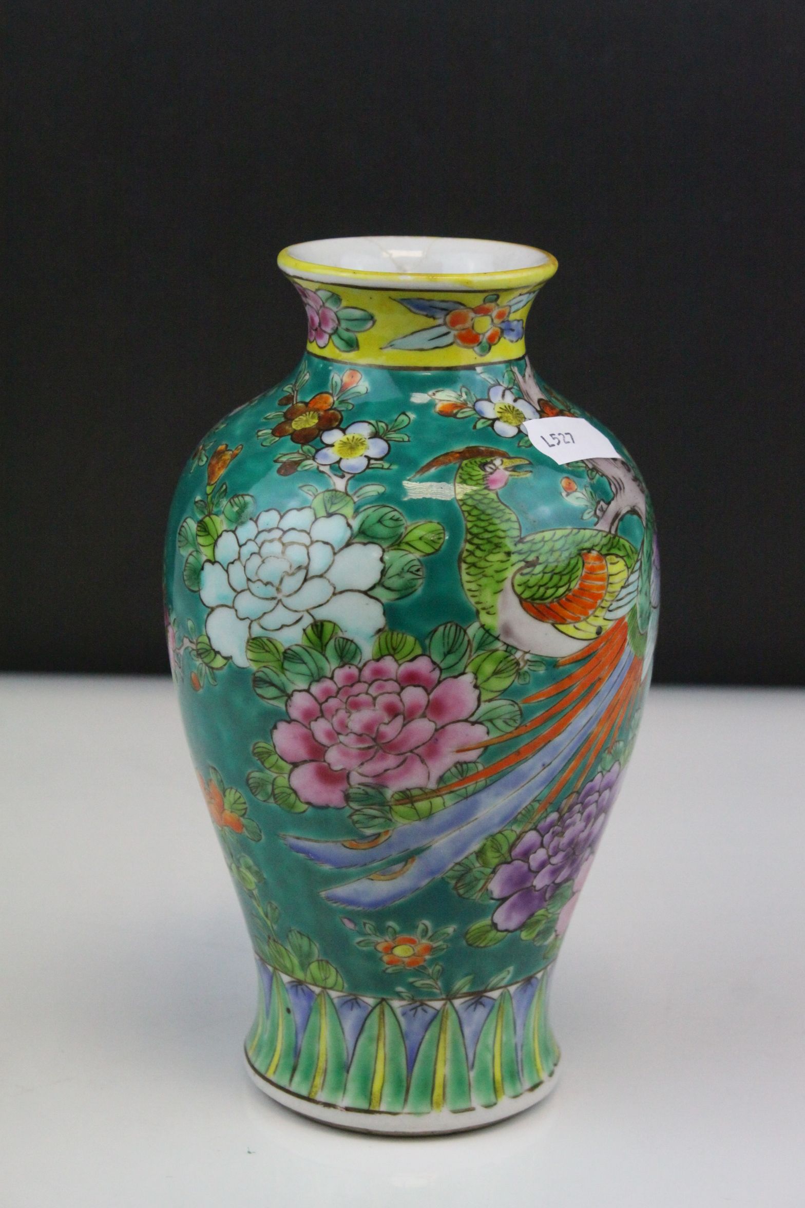 A chinese green ground vase decorated with flowers and exotic birds.