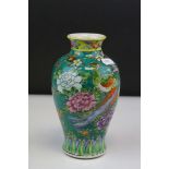 A chinese green ground vase decorated with flowers and exotic birds.