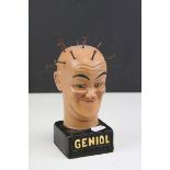 Plaster Bust of a Man with Nails in Skull stood on a plinth marked ' Geniol ', 18cms high