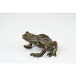 a bronze figure of a frog in squatting position.