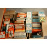 A large quantity of vintage Penguin and Pelican paper books in three boxes.