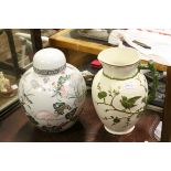 A late 19th century ceramic jug with embossed bird on a branch decoration together with a ginger jar