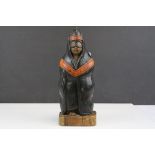 Carved Wooden Figure of a Masked Person wearing a Hood Cape, possibly South American, 29cms high