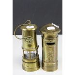 A novelty moneybox in the form of a postbox and a brass musical miners lamp.