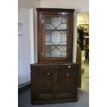 George III Oak Corner Cabinet comprising an upper section with single glazed astragel door over a