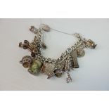 Silver Charm Link Bracelet with Silver Heart Shaped Lock holding a good quantity of charms
