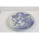 A Chinese blue and white charger / plate decorated with exotic birds in a garden setting.