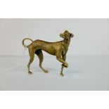 A brass bronze figure of a dog.