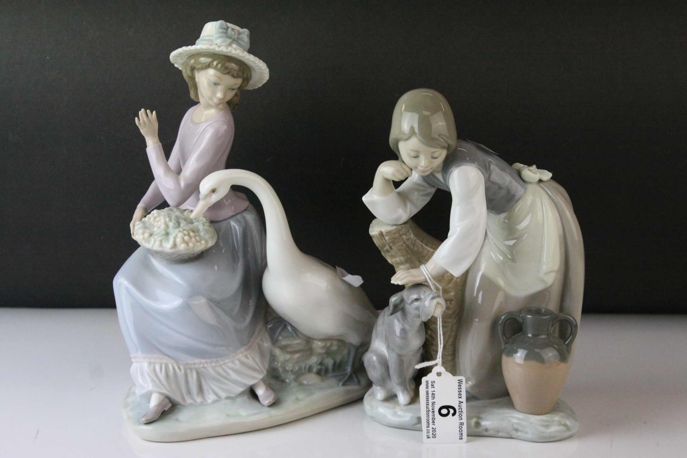 Two Lladro Figures, Caress and Rest, model no. 1245, 21cms high and a Seated Girl holding Flower