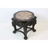 Chinese Hardwood Stand with marble top, the heavily carved base with four legs terminating in ball