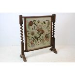 20th century Oak Firescreen with barley-twist supports and a needlework panel, 72cms wide x 78cms