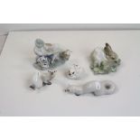 A group of figures to include a Lladro rabbit a farmer with bull and two Russian Ermins and a