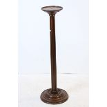 19th century Mahogany Jardiniere Stand with fluted turned support and circular plinth base, 103cms